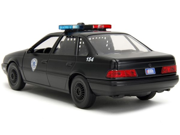 Ford Taurus OCP Matt Black "Detroit Police" and Robocop Diecast Figure 35th Anniversary "Robocop" (1987) Movie "Hollywood Rides" Series 1/24 Diecast Model Car by Jada - Image 2